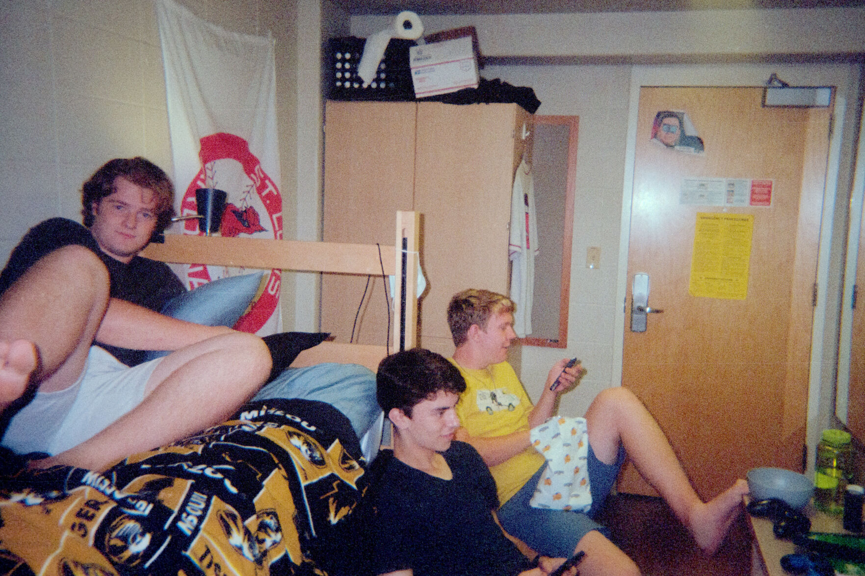 From left, Thomas Jamison, Matthew Newkirk, and Mason Arneson relax in Tom and I’s room